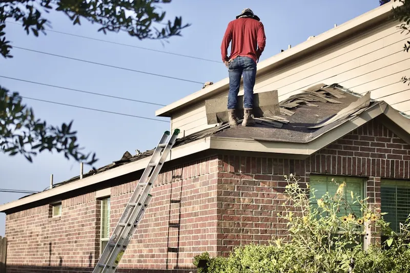 Professional roofer working on a residential roof in Pioneer Park